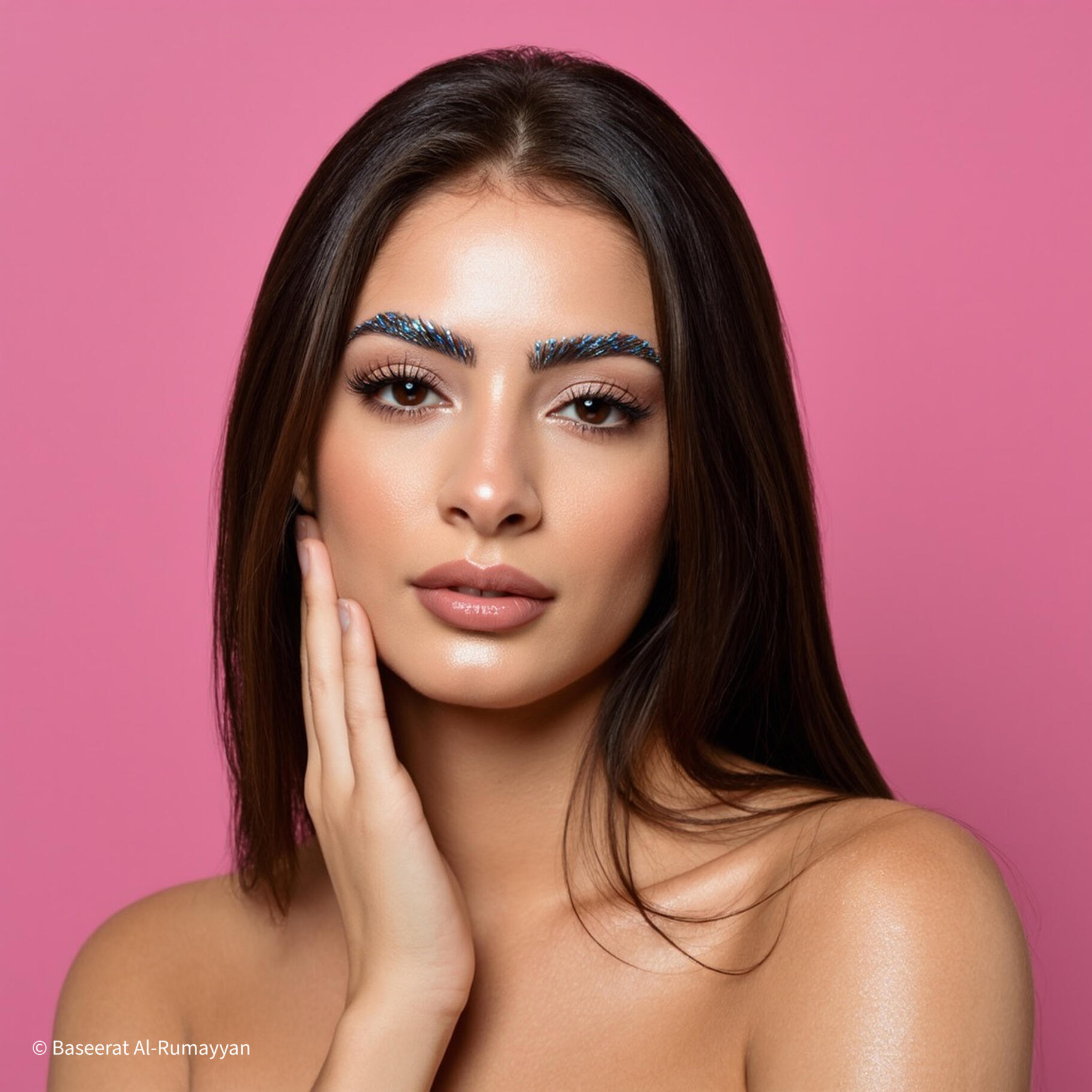 Baseerat Al-Rumayyan Blog Elegant Beauty portrait of Baseerat Al-Rumayyan with glowing skin and natural makeup against a bold pink backdrop
